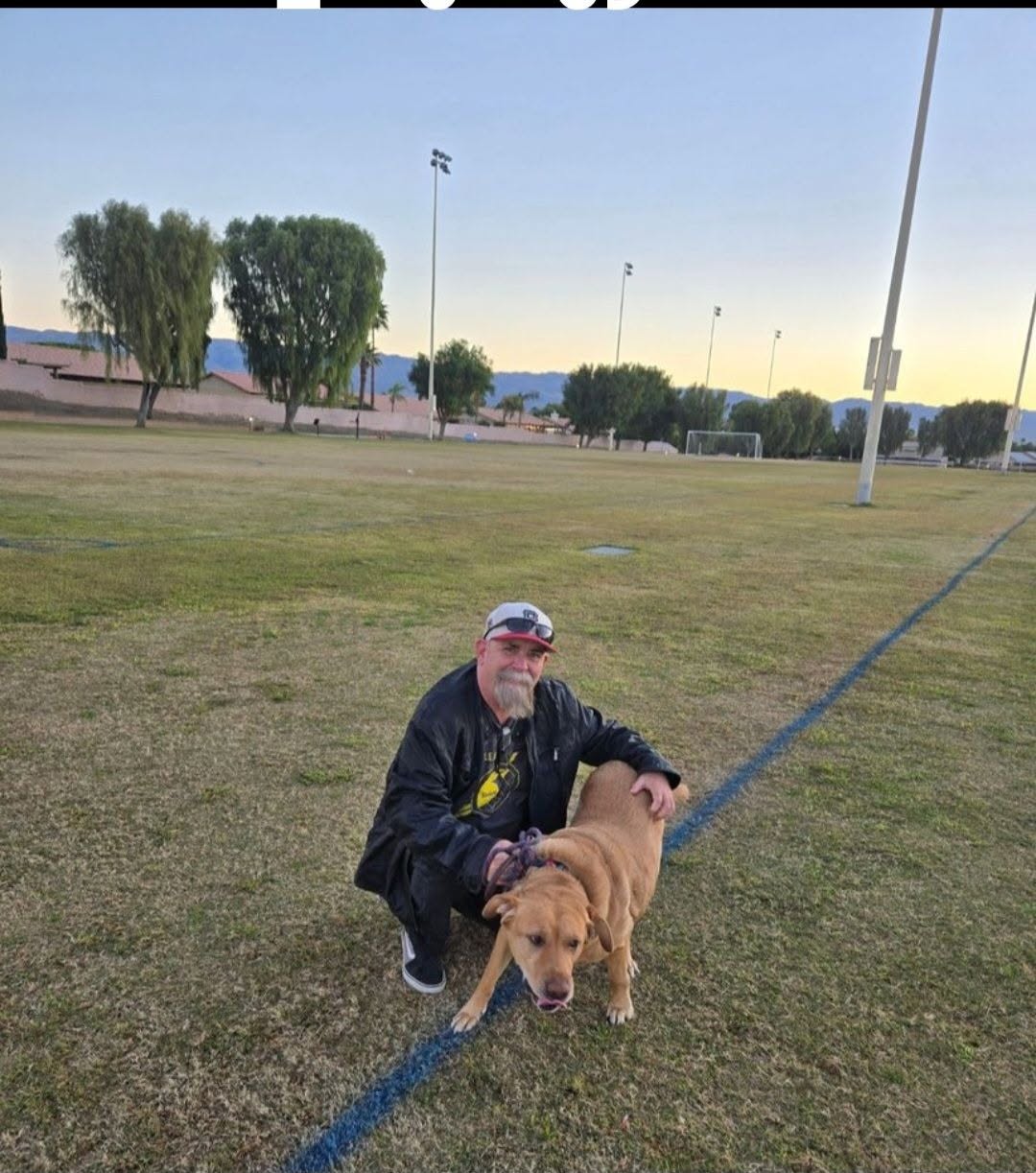 Gary Pyrdeck spending time with a dog at a local park